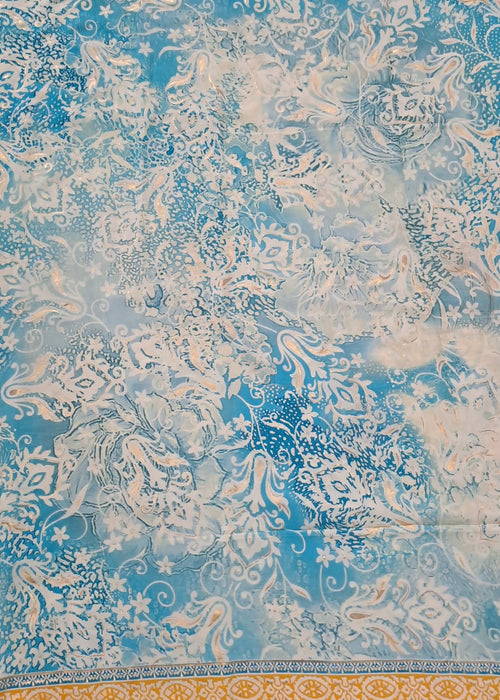 Decorative fabric with intricate patterns in blue and beige on a textured background