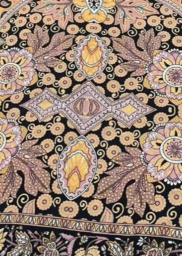 Decorative fabric with intricate floral and geometric pattern on a black background