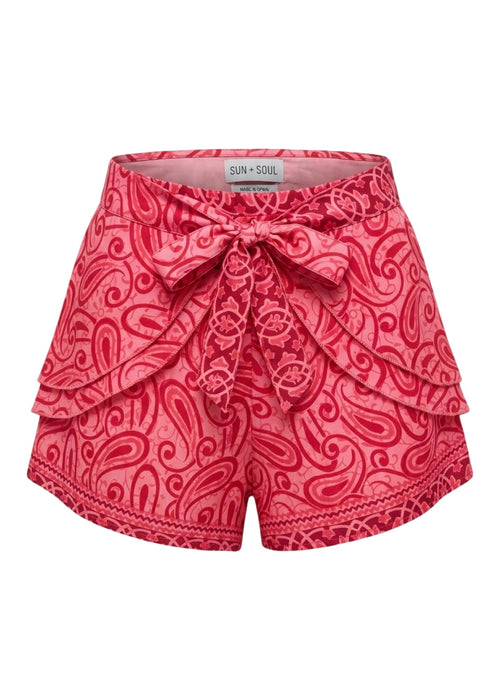 Red patterned shorts with a bow on a white background