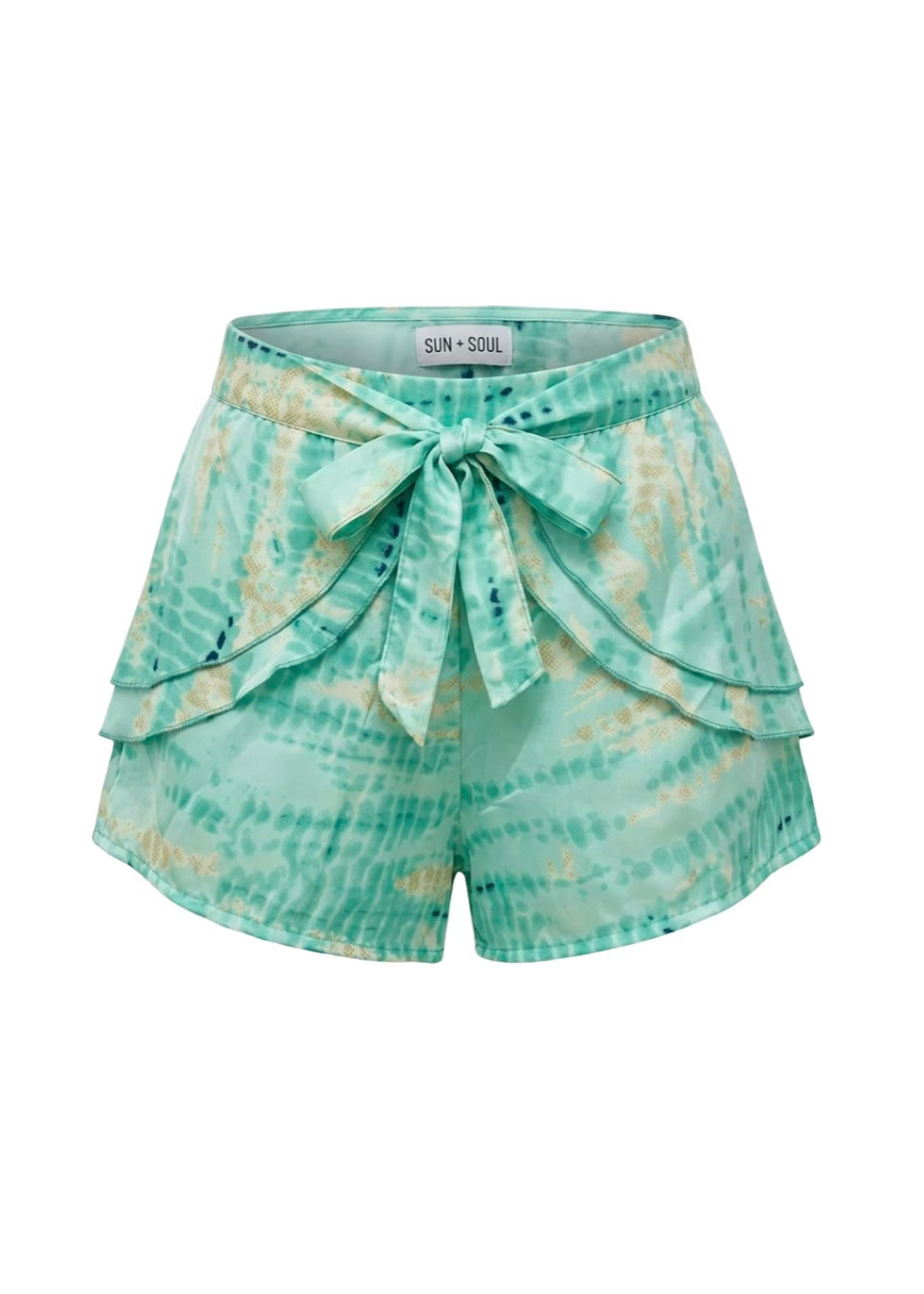 Teal tie-dye shorts with a bow detail on a white background