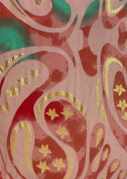 Decorative fabric with pink, green, and gold pattern stars