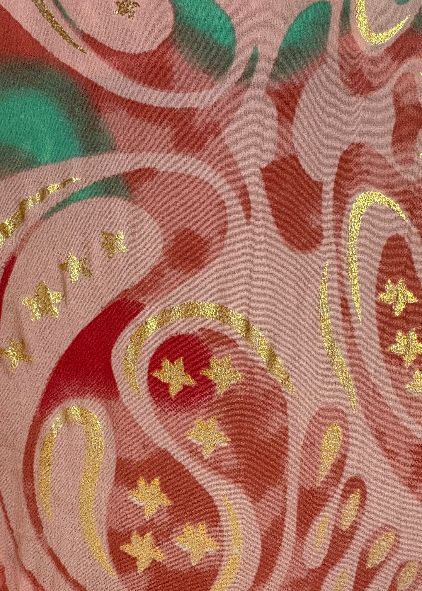 Decorative fabric with pink, green, and gold pattern stars