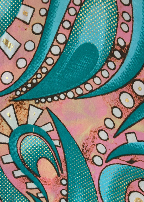 Close-up of a colorful pattern with teal, pink, and white elements.