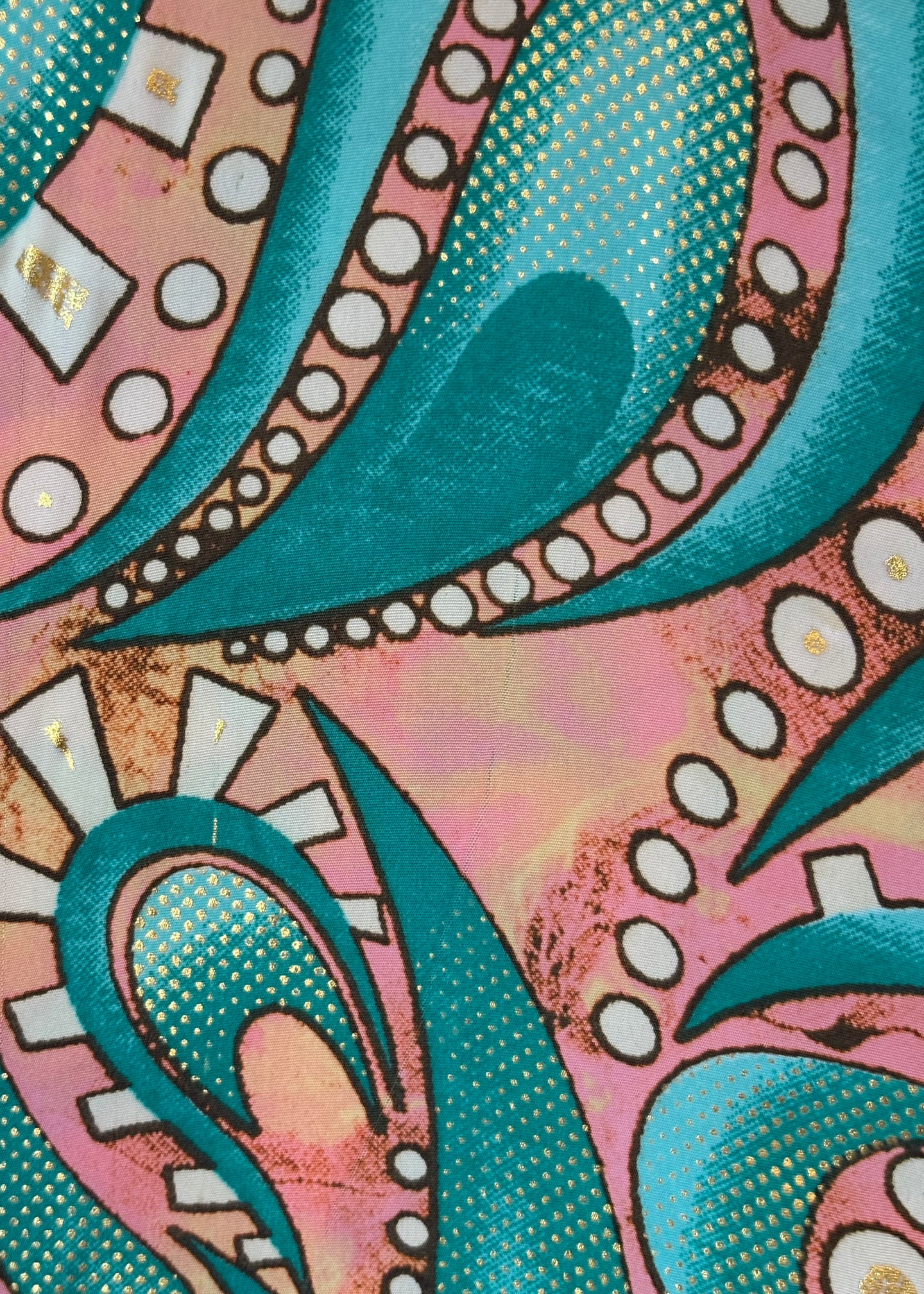 Close-up of a colorful pattern with teal, pink, and white elements.