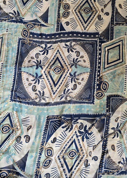 Patterned fabric with geometric and abstract designs in blue, white, and black.