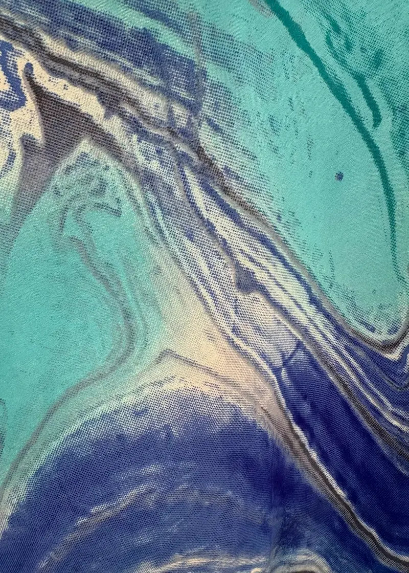 Close-up of a fabric with blue and green marbled pattern