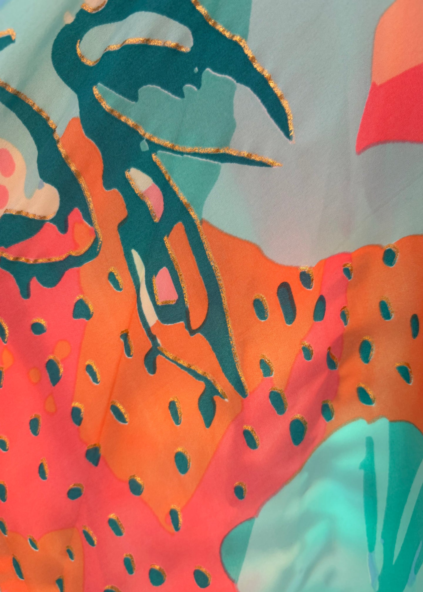 Colorful abstract design with orange, green, and red colors on a light blue background