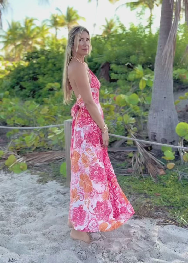 Woman in a floral dress standing on a beach