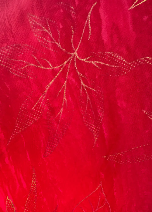 Close-up of red fabric with gold embroidery